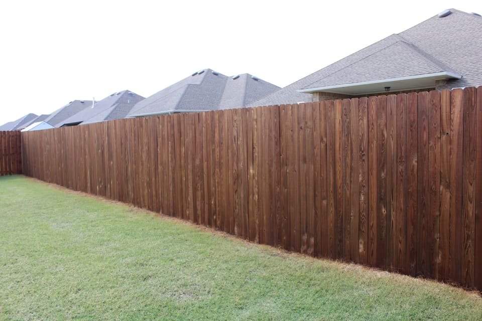 Fence stained with wood defender cedar tone fence stain.