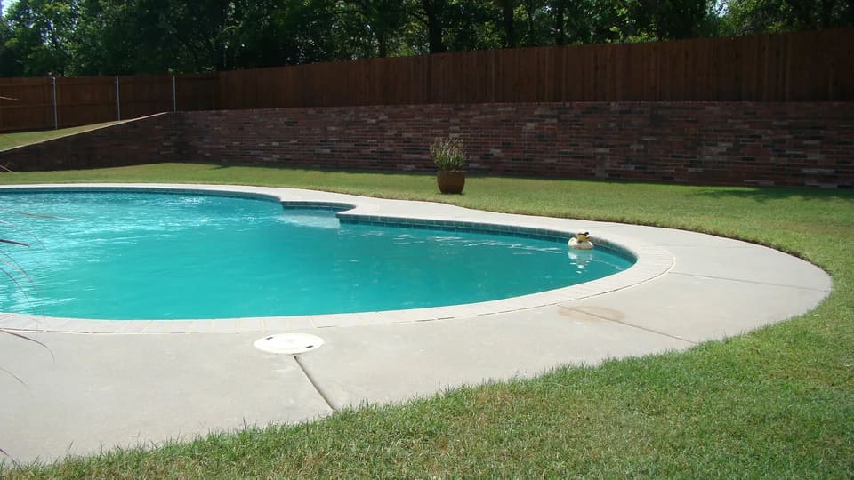 large fence in front of a pool