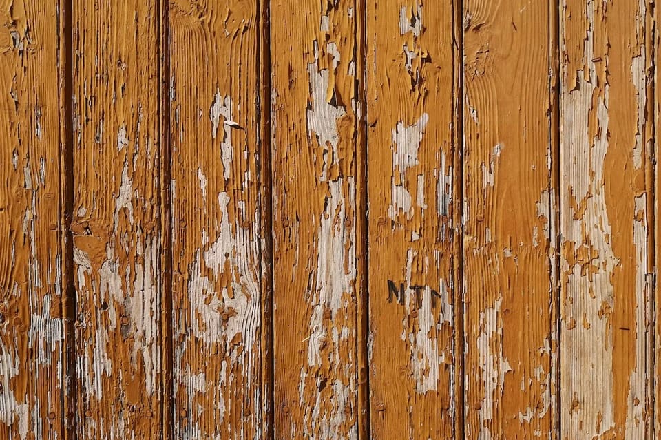 Flaking exterior paint that needs scraping and priming before repainting