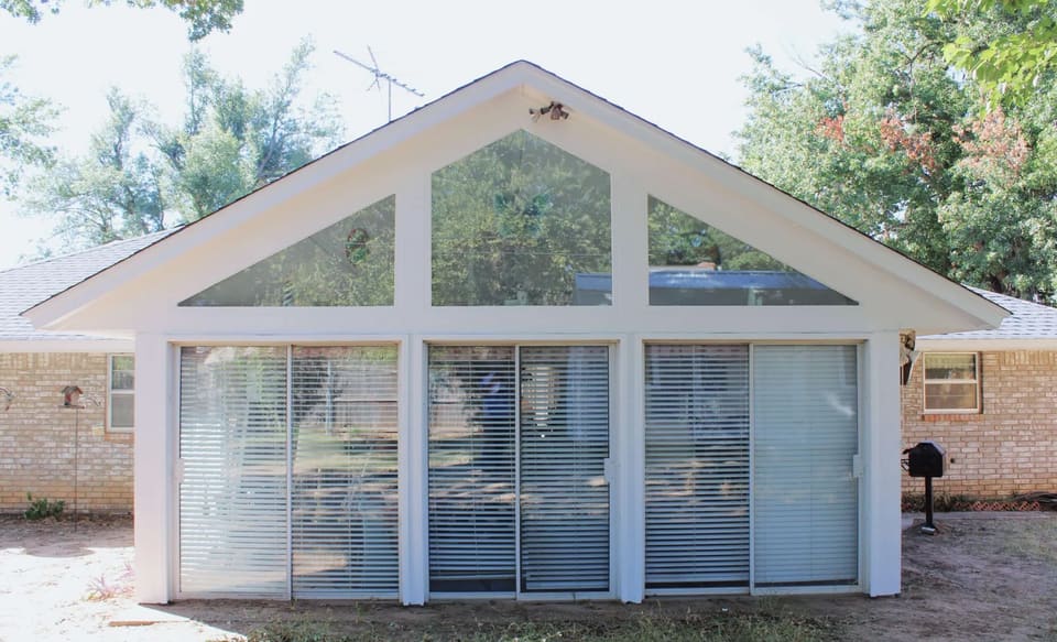 Sunroom gable and trim painted white on a Bethany, OK brick home