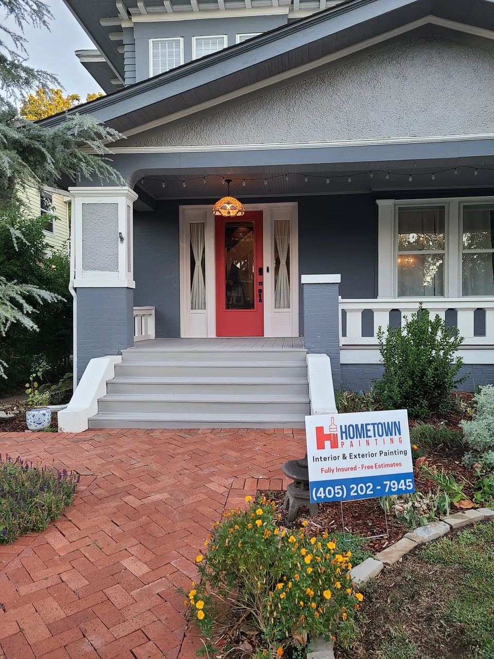 A historic Mesta Park home in OKC with a repainted porch and red front door