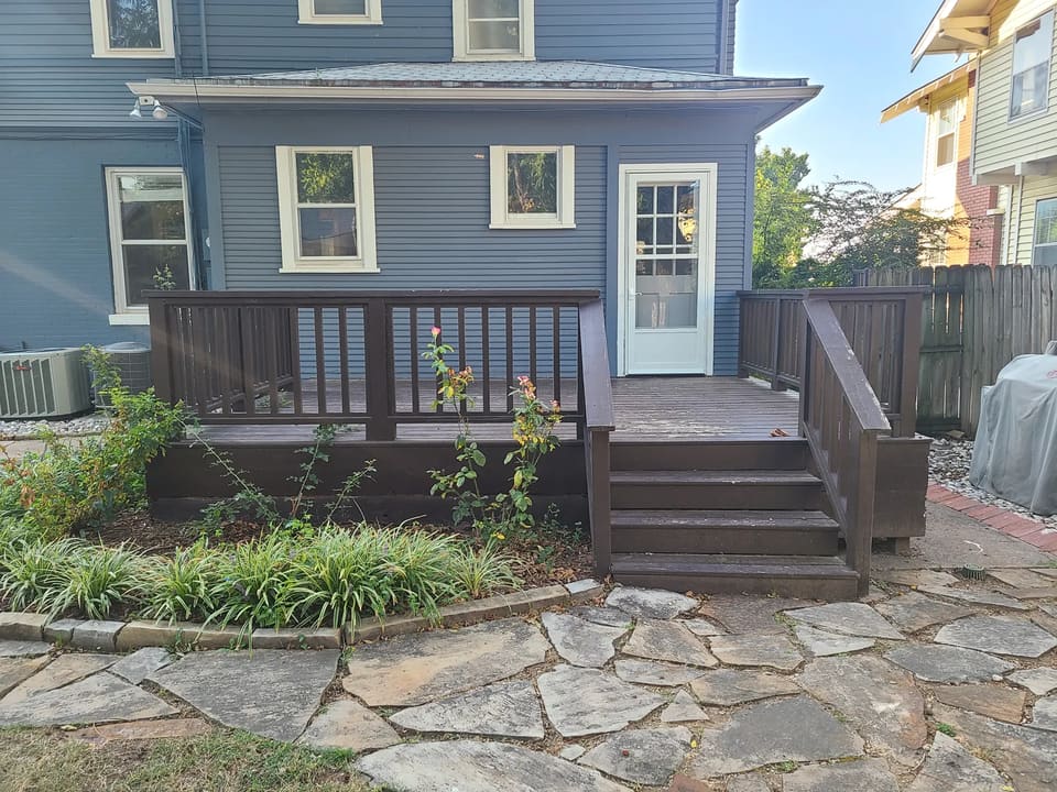Before: dark weathered deck and railing at the rear of a Mesta Park home