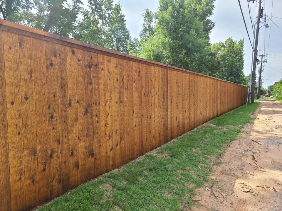 Long wood privacy fence in Mustang, OK freshly stained