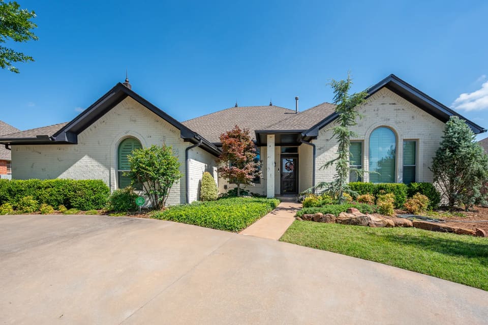 Cream painted-brick home in the OKC metro with a soft, textured mineral finish