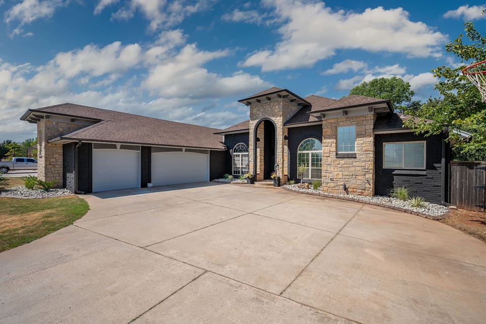 Stone and brick home in Edmond, OK after the brick was painted charcoal black by Hometown Painting
