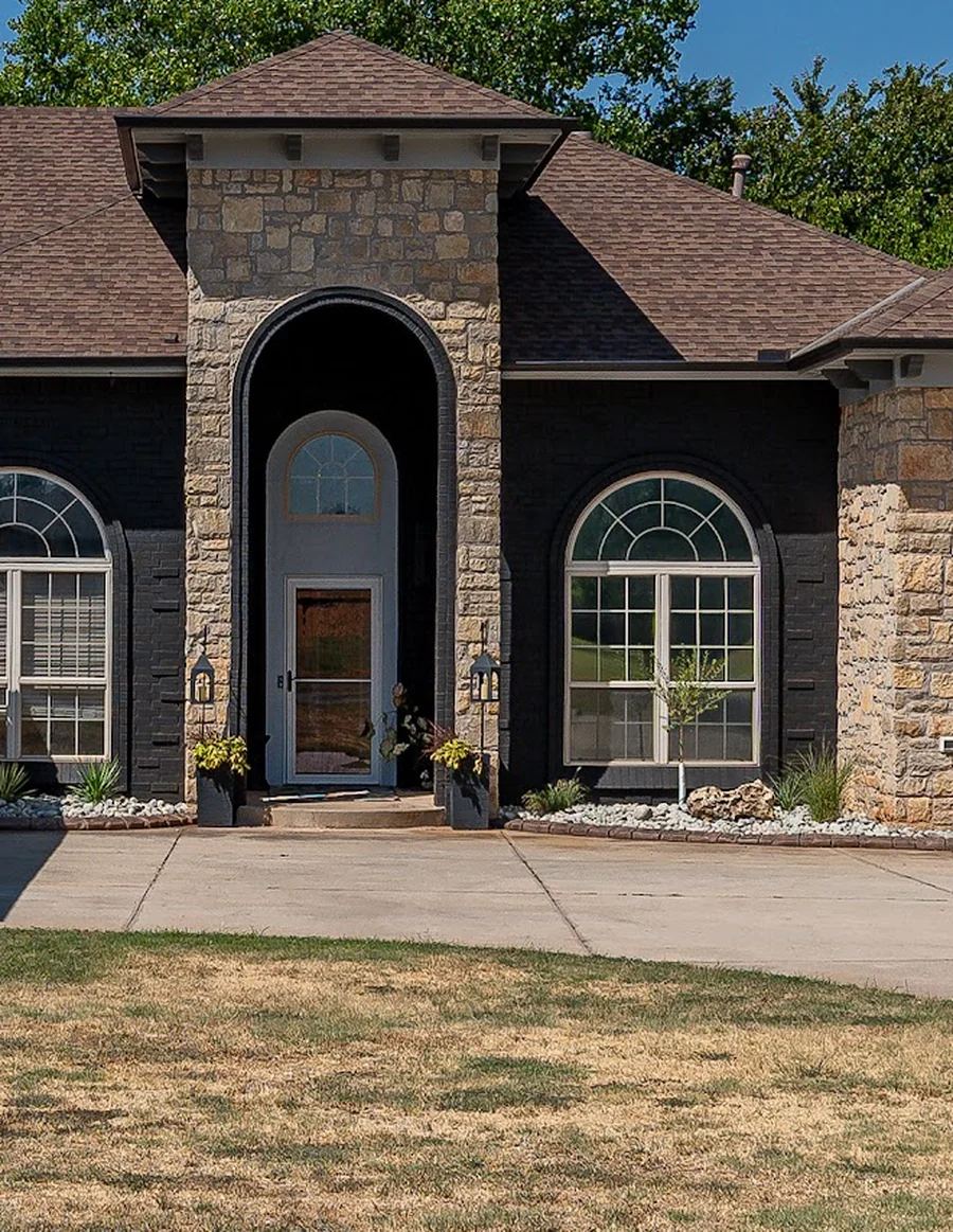 After: the same entry arch with the brick painted Celtic Stone charcoal black and the stone left natural